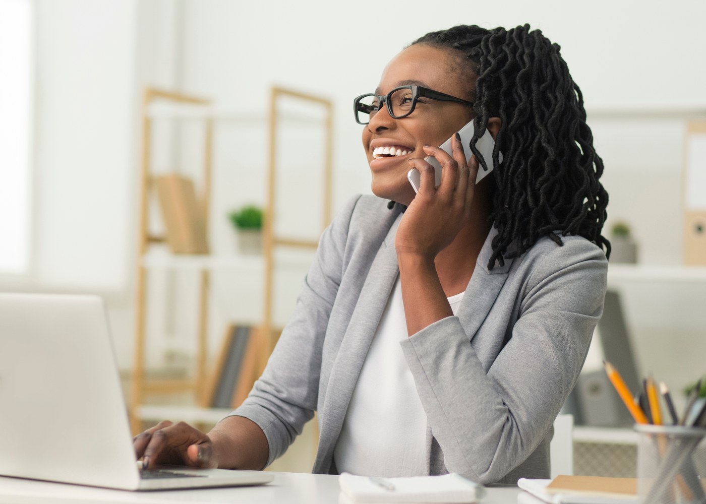 A business owner on the phone at her desk, responding to an offer that reached her.
